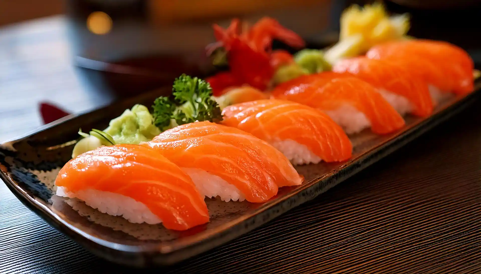 Salmon sushi platter with nigiri and rolls served with soy sauce and wasabi