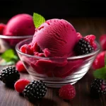 A scoop of black raspberry ice cream with fresh berries